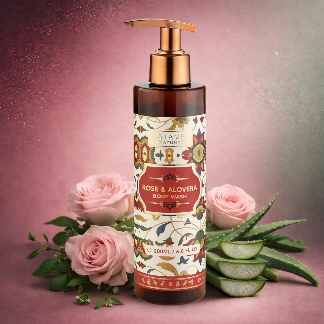 Body wash bottle with rose and aloe vera on a pink background