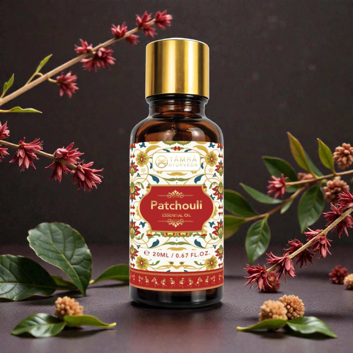 Patchouli essential oil bottle with decorative label surrounded by flowers and leaves on a dark background