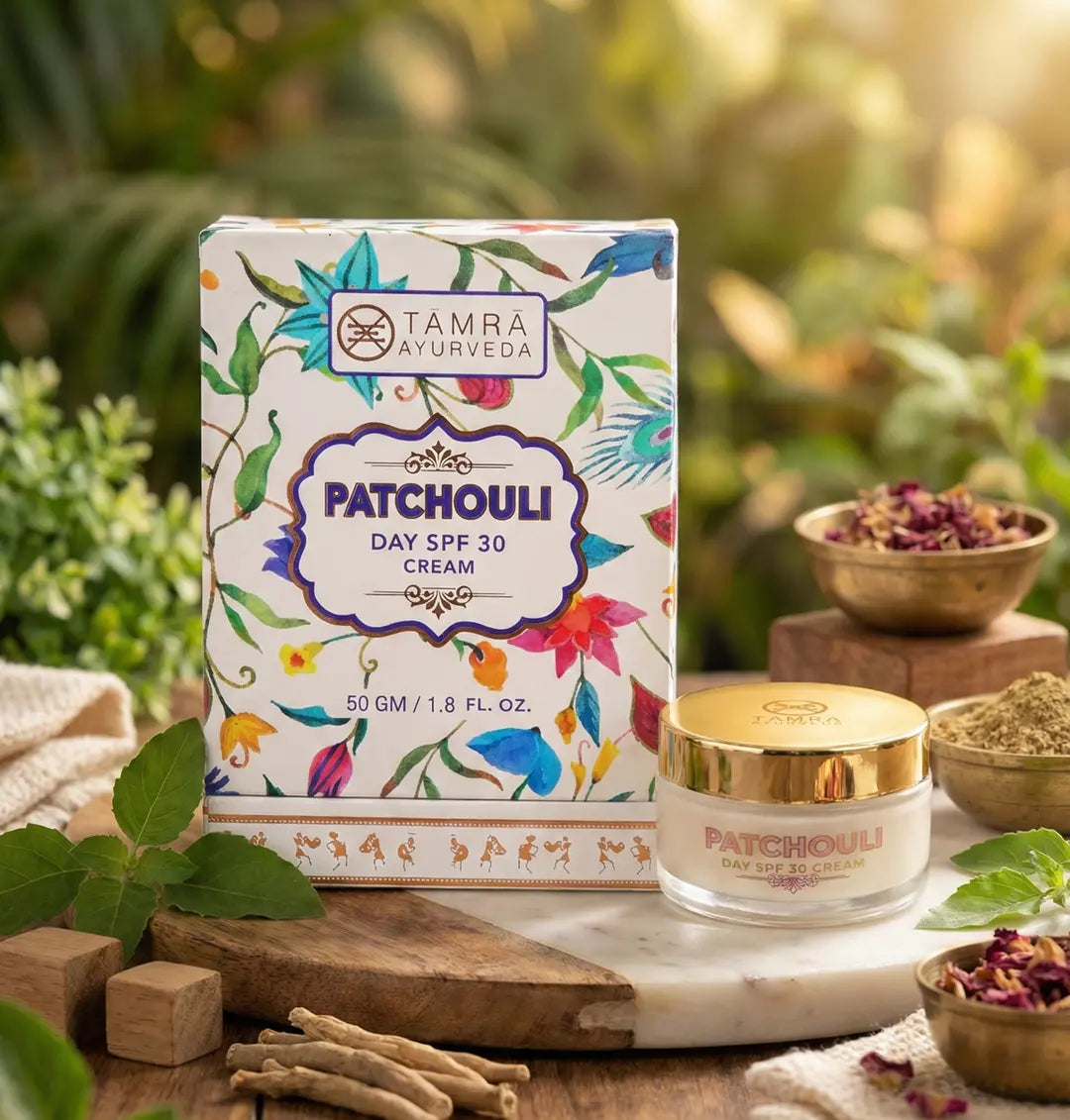 Tamra Patchouli day cream and packaging with natural elements on a wooden surface