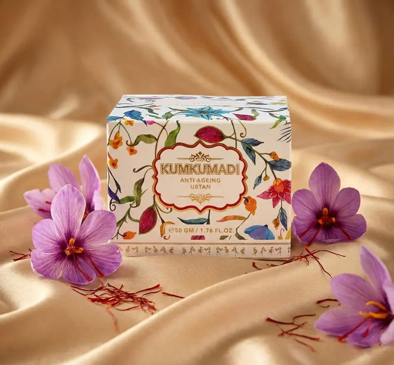 Kumkumadi product box with purple flowers on a beige fabric background