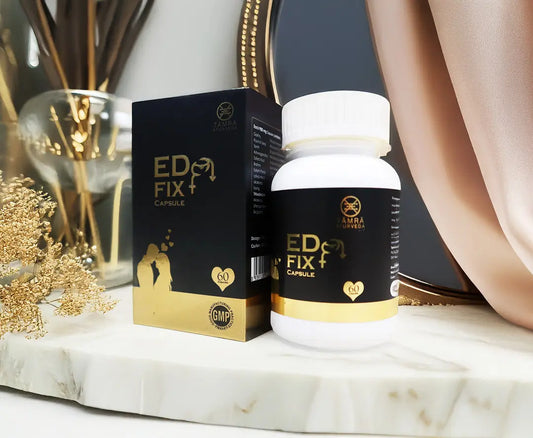 ED Fix+ capsule bottle and packaging on a marble surface with decorative elements.