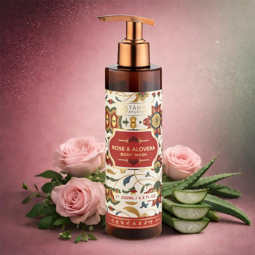 Body wash bottle with rose and aloe vera on a pink background