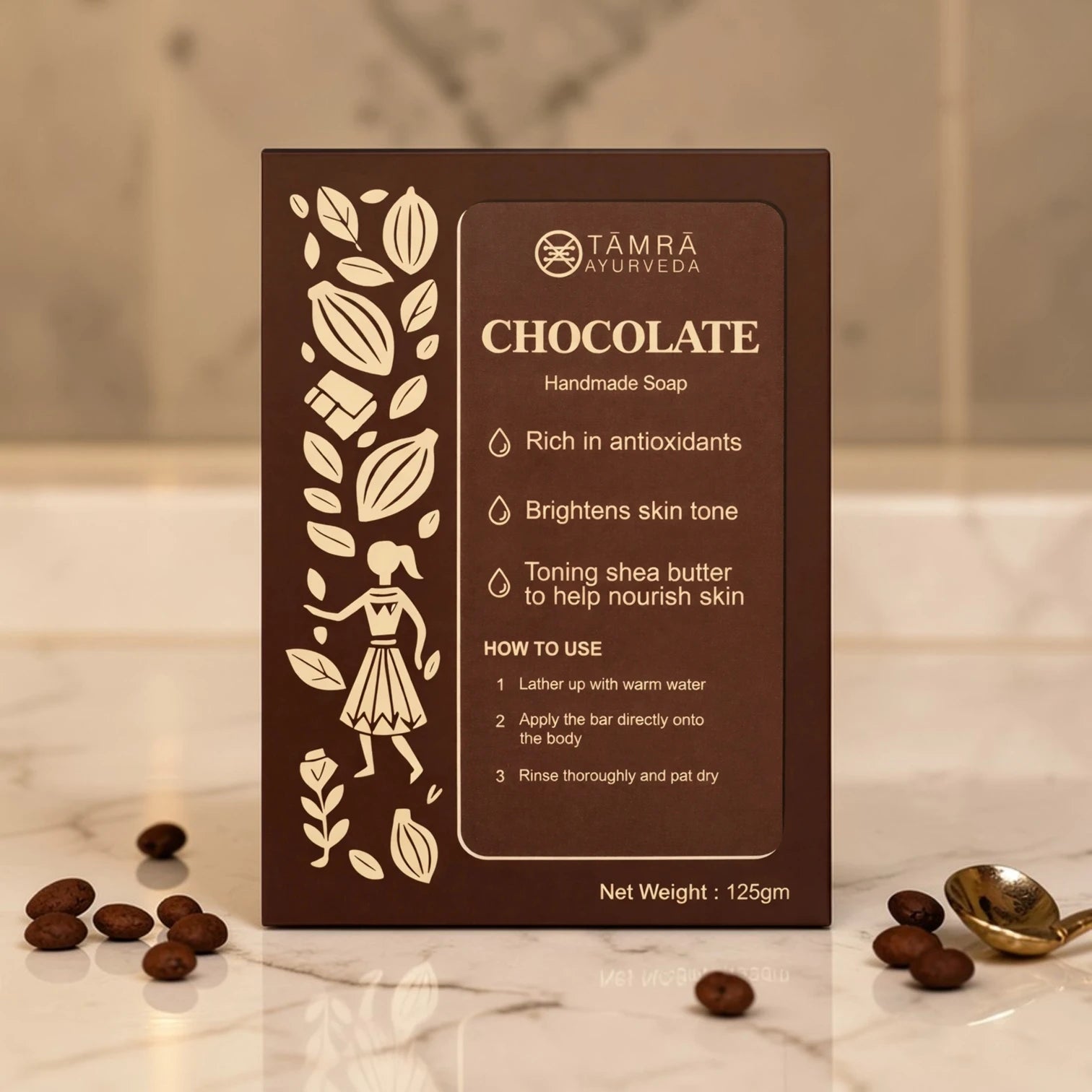 Tamra Ayurveda chocolate handmade soap packaging on a marble surface with cocoa beans.