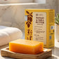 Mango and Shea Butter soap bar on a wooden stand with packaging in the background, featuring Tamra Ayurveda branding.