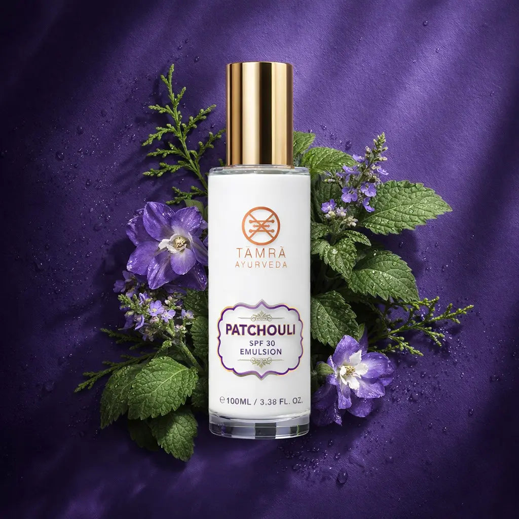TAMRA AYURVEDA Patchouli Emulsion bottle with flowers and leaves on a purple background