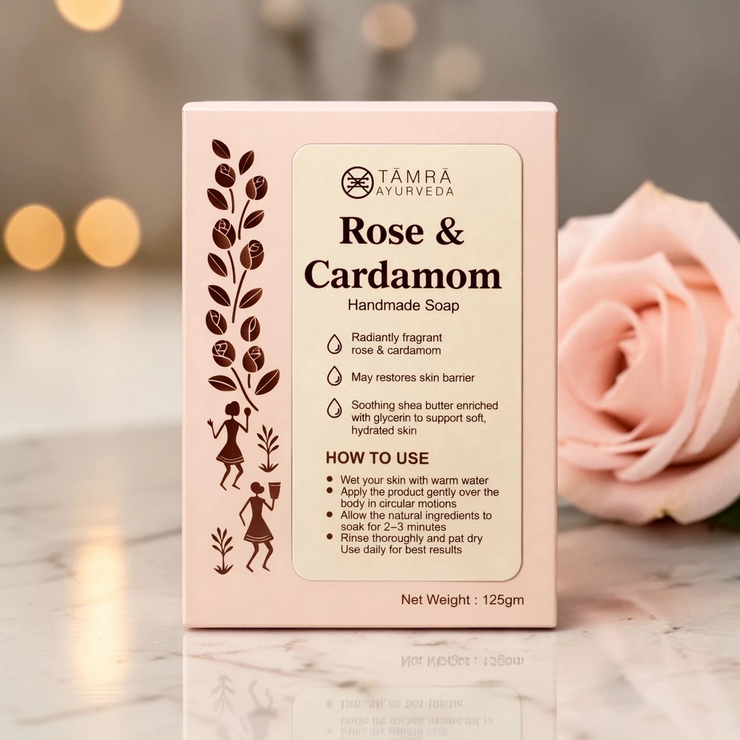 Tamra Ayurveda Rose & Cardamom handmade soap packaging with a blurred rose in the background
