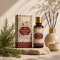 Tamra Ayurveda Rosemary essential oil bottle and packaging on a wooden surface with decorative elements.