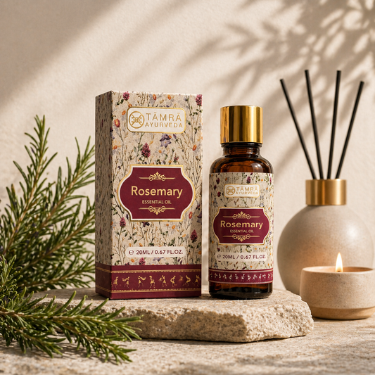 Tamra Ayurveda Rosemary essential oil bottle and packaging on a wooden surface with decorative elements.