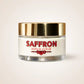 Jar of saffron repair scrub with a gold lid on a beige background