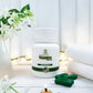 Tamra Tagara capsules and box on a white surface with flowers and candles