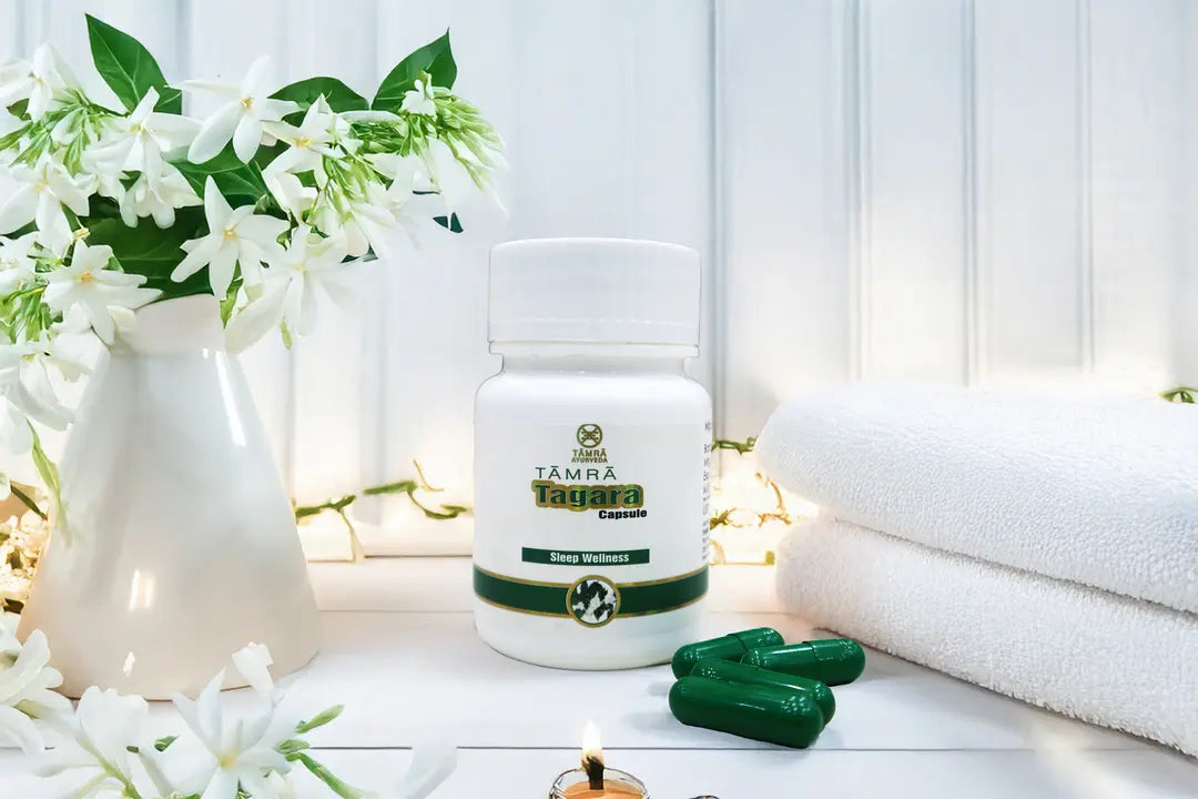 Tamra Tagara capsules and box on a white surface with flowers and candles