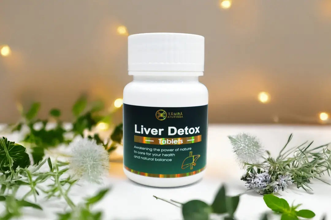 Bottle of Tamra Liver Detox tablets with greenery background