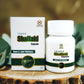 Tamra Shailaki capsules and box on a wooden surface with green leaves in the background