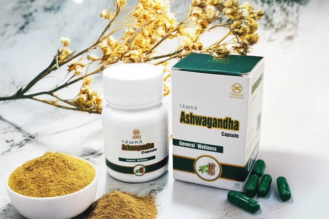 Tamra Ashwagandha capsules, powder, and packaging on a marble surface with flowers.
