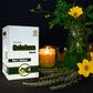 TAMRA Gokshura capsule box with candles and flowers on a dark background
