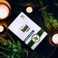 Candlelit scene with a box labeled 'Tamra Tulsi Capsule' on a dark surface.