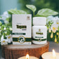 Tamra Tagara Capsules packaging and bottle on a wooden stand with flowers and candles in the background