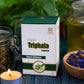 Box of Tamra Triphala Capsules with jars and a bowl of dried flowers on a textured surface.
