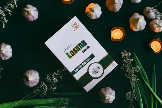 Tamra Lasuna Capsule packaging on a dark surface with garlic bulbs and candles.