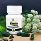TAMRA Karela Capsule bottle with green capsules and herbs on a dark background
