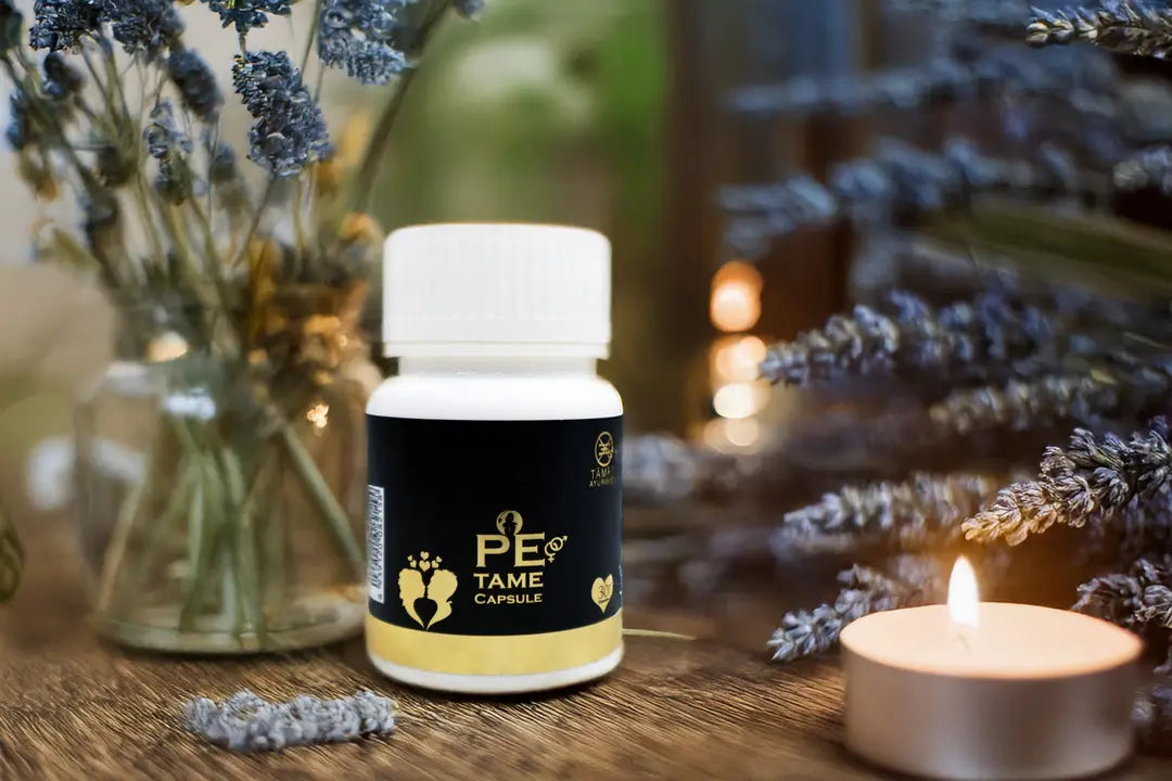 Capsule bottle labeled 'PE TAME' on a wooden surface with lavender and a candle in the background