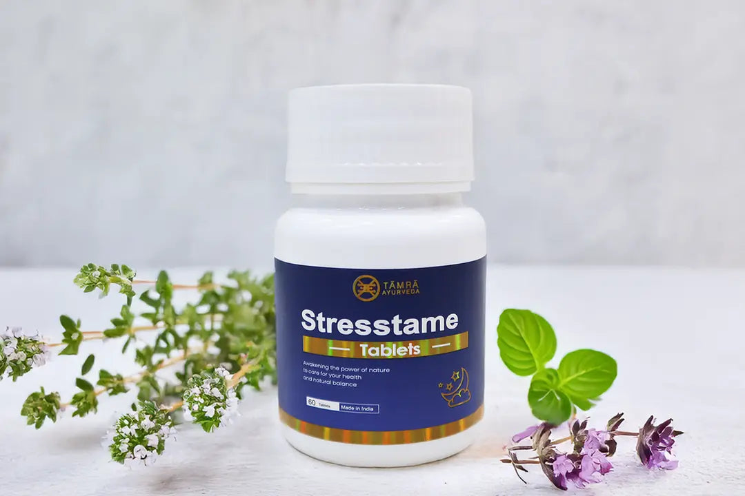 Bottle of Stresstame tablets with a white background and greenery