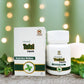 Tamra Tulsi capsules and packaging on a table with candles and greenery.