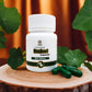 Tamra Brahmi capsule bottle on a wooden surface with green capsules. 