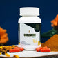Curcumin supplement bottle with turmeric powder and flowers on a dark background