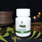 Tamra Neem capsule bottle with green leaves on a dark background