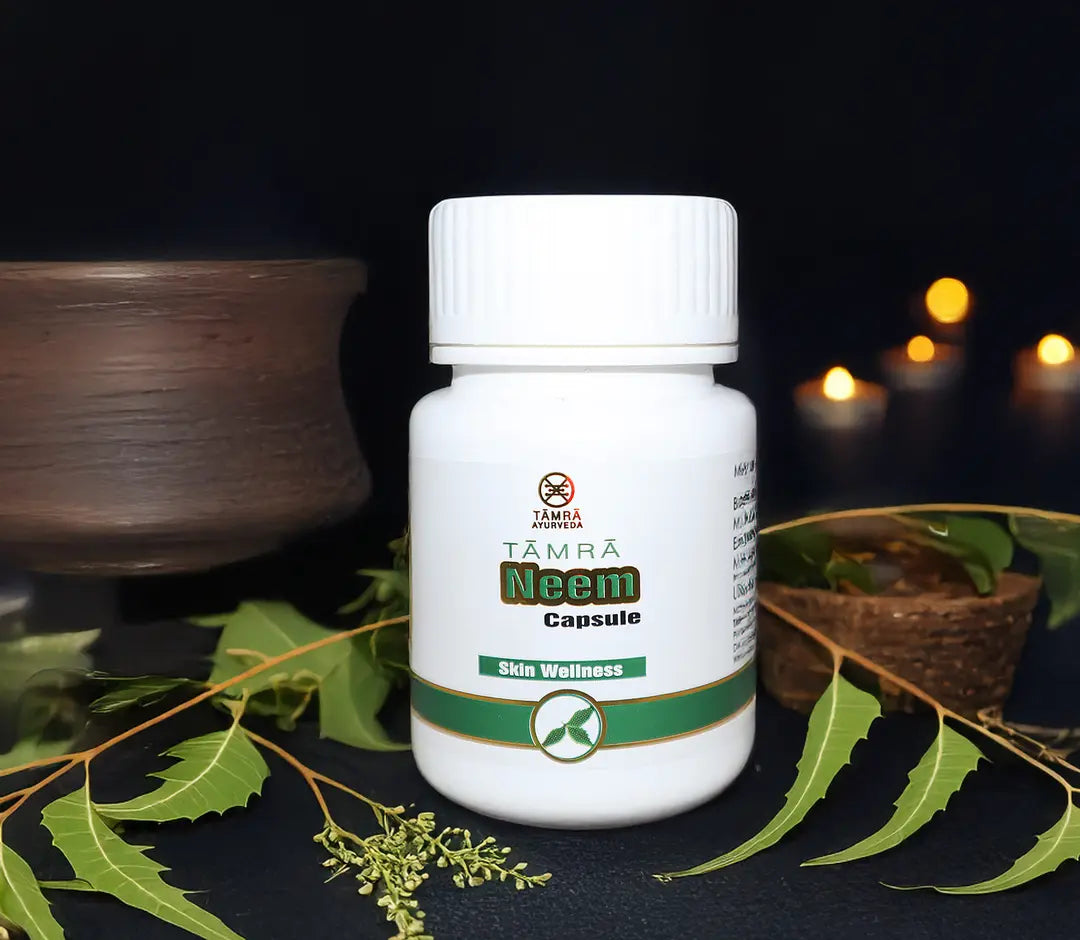 Tamra Neem capsule bottle with green leaves on a dark background