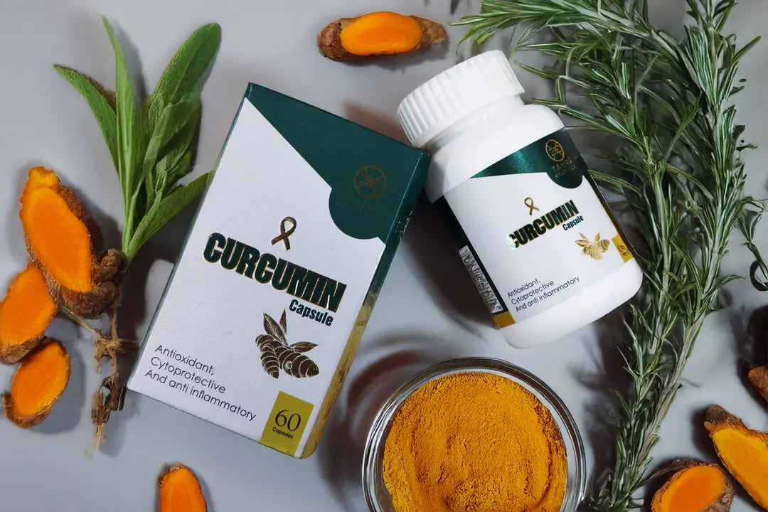 Curcumin capsules with packaging, turmeric roots, and powder on a gray background