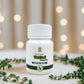 White bottle labeled 'Tamra Tulsi' with green leaves on a blurred background
