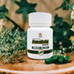 Tamra Ayurveda Amalaki capsule bottle on wood with green capsules