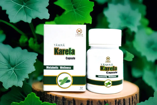 Tamra Karela Capsule packaging and bottle on a wooden stump with green leaves in the background