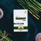Tamra Shatavari capsule box with green leaves and candles on a dark background
