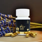 Supplement bottle labeled 'PE TAME' by Tamra Ayurveda with capsules and lavender on a wooden surface.