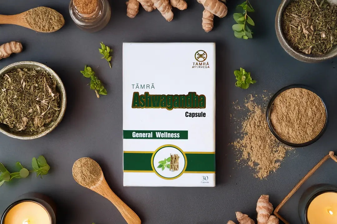 Box of Tamra Ashwagandha capsules surrounded by natural ingredients on a dark surface