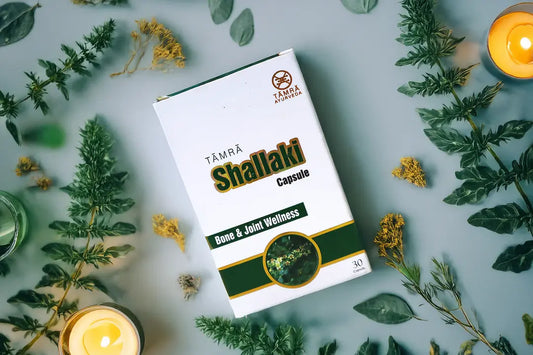 Tamra Ayurveda Shallaki capsule box surrounded by green leaves and candles.