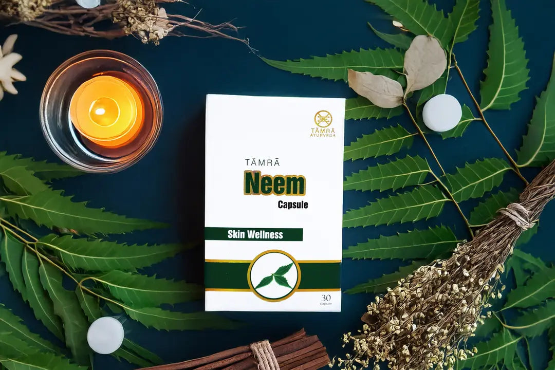 Neem capsule packaging with a candle and leaves on a dark background