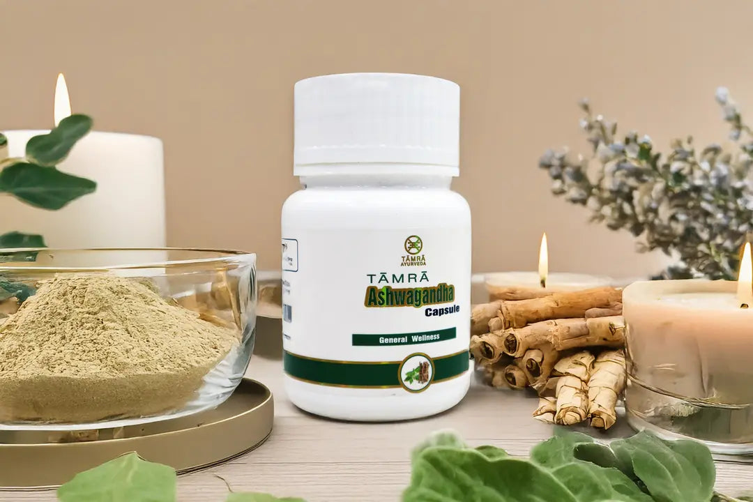 Tamra Ashwagandha capsule bottle on a table with ashwagandha roots and leaves.