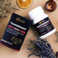Tamra Testoboost supplement bottle and packaging on a textured surface with dried plants and candles.